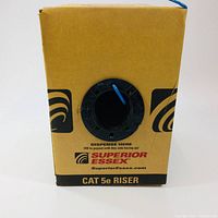 Front view of brown cardboard box labeled Superior Essex Cat 5e Riser with blue cable spool dispenser.