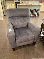 Front view of gray upholstered reclining chair showing seat, arms, and backrest.