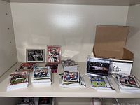 Multiple stacks of Panini Absolute Football cards laid out on a shelf, showing various players and designs.