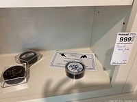 Three signed hockey pucks, one with certificate of authenticity shown in white and black writing on certificate.