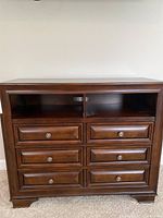 Front view of media cabinet with six drawers and two open shelves.