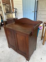 Solid walnut antique washstand with backsplash and towel bars showing overall condition and finish
