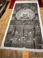 Full view of the vintage black and white stone rubbing artwork on traditional Chinese paper laid flat on wooden floor, showing the full length and details of the print.