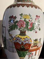 Close-up of floral and decorative motifs painted on the vase surface.