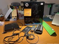 Full lot showing external DVD drive, two digital voice recorders with cases, wired earphones, and Sennheiser RS 125 headphones box.