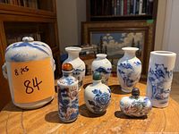 All eight porcelain pieces arranged on round wooden table