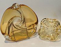 Front angled view of both blown art glass ashtrays/bowls showing amber larger piece and smaller clear piece