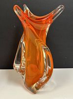 Front angle of the orange and clear glass hand-blown vase showing unique organic three-point shape