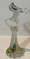 Side view of glass rearing horse sculpture showing clear glass and colored accents