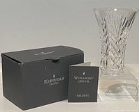 Photo of Waterford branded black box, clear crystal vase, and booklet.