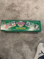 Closed green box labeled 'Baseball 1990 Complete Set' showing several player cards on the top.