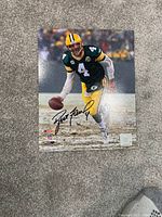 Glossy color photo of Brett Favre in Green Bay Packers uniform, signed in black marker.
