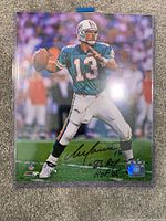 Full view of the Dan Marino autographed photo showing the NFL hologram sticker and inscriptions.