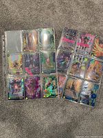 Photo showing 15 Dragon Ball Z trading cards in protective binder sleeves arranged in three columns. Cards have holographic and foil artwork featuring various characters from the series.