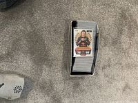 Photo showing a box filled with a large stack of F1 Match Attax cards with one card on top featuring a Red Bull Racing F1 driver in racing suit.