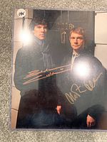 Color photograph of Sherlock Holmes and Dr. John Watson with gold ink autographs