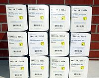 Photo showing 12 boxes of HP CE412A / 305A Yellow toner cartridges arranged in a grid.