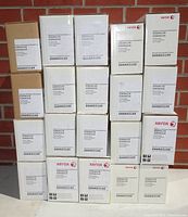 Twenty white and brown boxed black toner cartridges stacked in four rows with visible Xerox brand and part numbers X203A11G, X203A21G, 006R03109