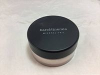 Top view of the BareMinerals Mineral Veil powder jar with black lid and branding.