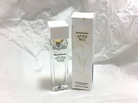 Photo of Elizabeth Arden White Tea Eau de Toilette 10ml perfume bottle and its packaging box placed on a white crumpled paper background.
