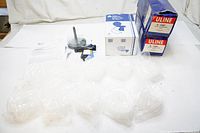 Photo of all items including two boxed packs of ULINE fasteners, the tagging tool, and instructions.