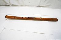 Full length view of the vintage bamboo flute showing the entire length and finger hole placement.