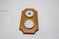 Full view of the vintage HAMPTON weather station showing the wooden mounting and two brass-bezel gauges.