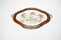 Full view of vintage wooden serving tray with silk embroidered flower basket under clear perspex.