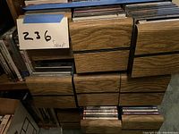 Photo showing entire 9 drawer CD holder filled with CDs and label 236+ cabinet