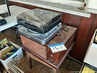 Three stacked turntables: one wooden vintage unit at bottom, Sharp DJ unit in middle, Audio-Technica on top.