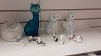 Full view of cat decor collection showing all items in lot on white surface