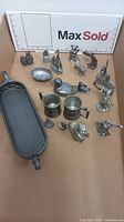Overview of the lot showing all miniature metal pewter items including mugs, ship, animal figurines, and tray