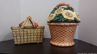 Front view showing two picnic basket cookie jars, one with sunflower lid and one with fruit lid