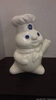 Front view of the Pillsbury Doughboy cookie jar showing the full figure with chef hat and smiling face.