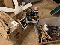 Box containing brackets, hangers, electric winches, and wiring.