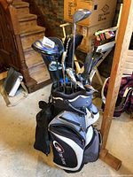 Full view of golf bag with multiple clubs inserted, showing overall contents and condition