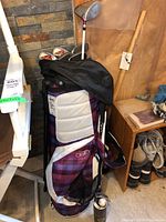 Photo of the Ogio plaid golf bag standing upright with golf clubs inside, showing the bag's pattern and compartments.