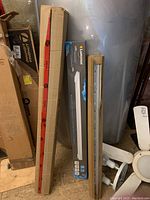 Boxes of Luminus LED shoplight fixture and Lite King T5 bulbs stacked in garage area.