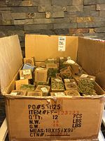 Photo of packed cardboard box containing multiple small boxes of stone critter figurines.