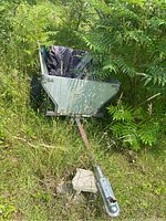 Oblique front view of trailer and tongue angled into overgrown grass