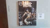 Front cover of the 1994 Special Issue Heavy Metal Greatest Hits magazine featuring fantasy-style artwork of two characters in sci-fi/metallic armor.