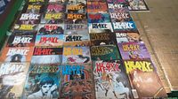 Photo showing a top-down view of multiple Heavy Metal magazine covers arranged in rows, depicting fantasy and sci-fi themed artwork.