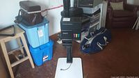 Full view of the Vivitar VI photo enlarger standing on white baseboard, showing the entire unit with background items.