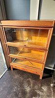Front view of four-section oak barrister bookcase with glass doors