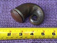 Curved horn snuff box shown on purple fabric with measurement tape indicating approx 4.5 inches length