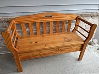 Front view of pine bench with storage seat closed