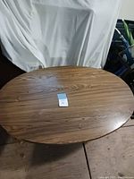 Photo of oval wood table top showing wood grain and smooth finish.