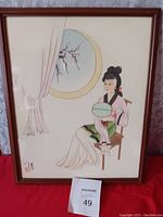 Framed Chinese traditional wall art painting showing a woman sitting with a fan and a circular window with plum blossoms.