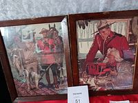 Two framed Arnold Friberg art prints showing Mounties and horses, with some scratches on frames