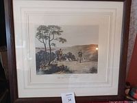 Framed shooting print featuring two men with three dogs in a country landscape, showing the full artwork and frame.